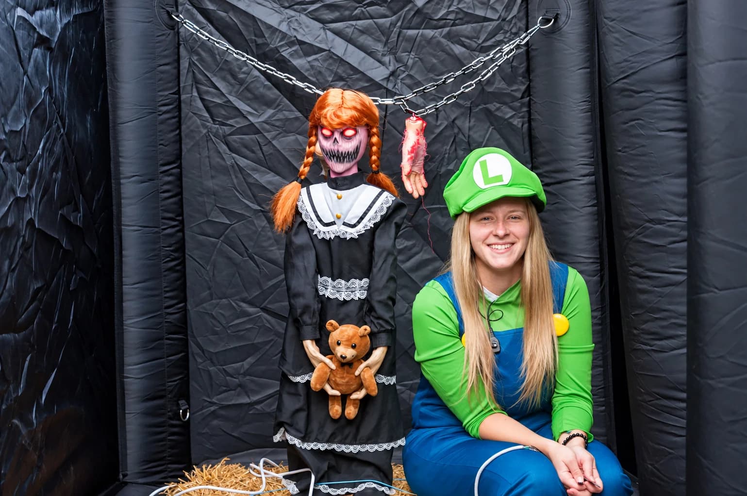 A cheerful Luigi beside the haunted-house doll.
